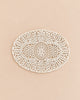 Oval off-white crocheted doily with an intricate, symmetrical floral pattern, displayed under a Maileg Christmas Mice Set.