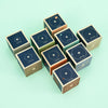A collection of Uncle Goose Planet Blocks with celestial patterns and solar system planets printed in gold on a teal background.