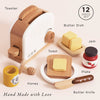 The Pop-up Toaster & Breakfast Set is a 12-piece wooden pretend play set, including a toaster, toast, butter dish, jam jar, honey pot, plate, and butter knife—each "Hand Made with Love" from FSC-certified wood. Ships in one week.