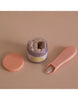 The "My Tiny Birthday Set - Tiny Harlow" features a whimsical peach-hued jar and tweezer-like tool, revealing sprinkle-covered bandages inside as if they're party accessories.