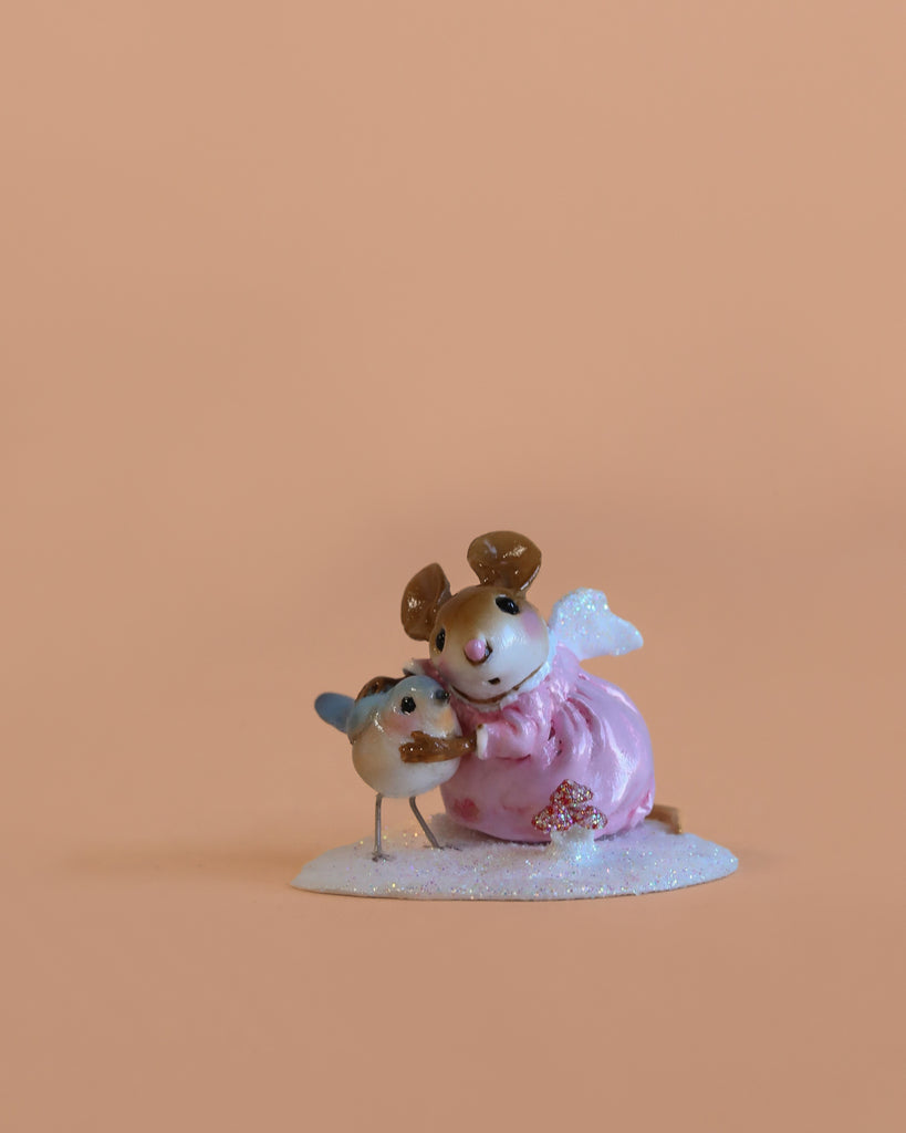 The Wee Forest Folk Tiny Collectible - Loving Angel (Not a Toy) features a hand-sculpted mouse in a pink dress with angel wings hugging a tiny mouse with blue wings, set against a plain peach background.