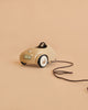 The Maileg Car, Mouse - Wheat is a small beige toy car with a steering wheel and white wheels, attached to a brown pull string, displayed against a plain beige background.