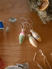 The Grapat Ornament Set - Winter Sparkles features three hand-painted ornaments with string loops, displayed on wood beside dried greenery, an orange slice, and blue thread—festive accents for enchanting home decor.