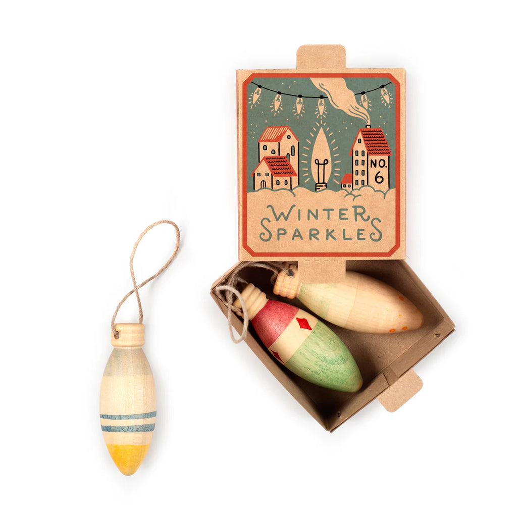 The Grapat Ornament Set - Winter Sparkles features three hand-painted vintage bulb-shaped ornaments in an open box. One, with blue stripes, sits outside—ideal for magical holiday home decor and festive celebrations.