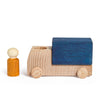 The Lubulona Wooden Truck - Blue features natural wood wheels, a blue cargo block, and comes with a small peg figure—ideal for fans of eco-friendly toys.