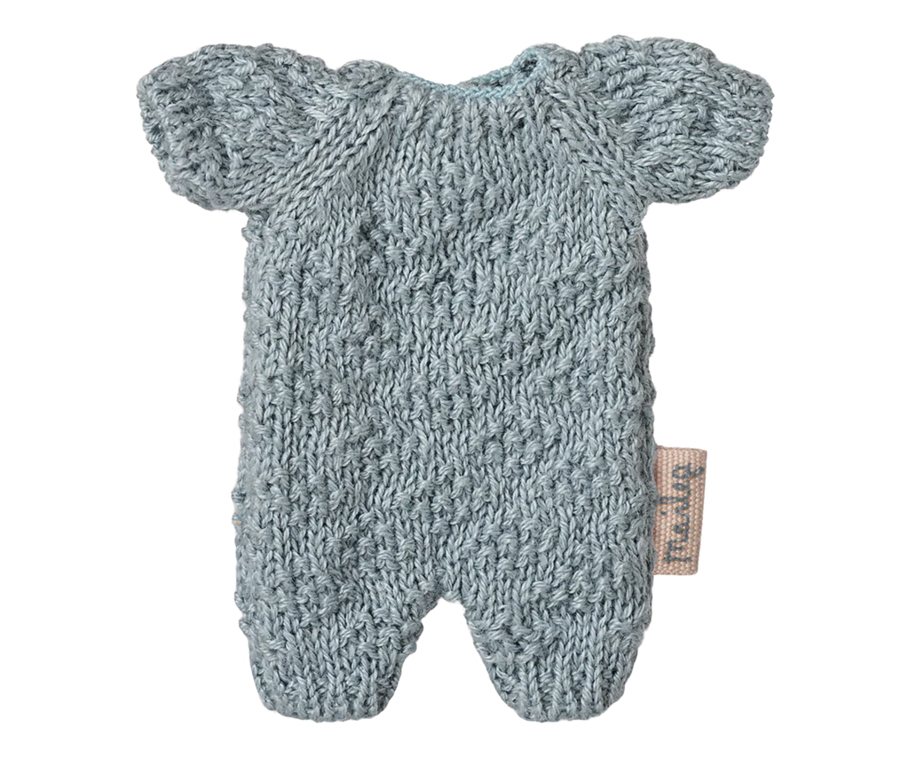 The Maileg Extra Clothing: Knitted Suit, Micro - Blue for Micro Bunny is a light blue, short-sleeved, textured romper with a fabric tag, shown flat on a white background—perfect for dressing up your micro bunny.