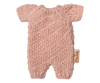 The Maileg Extra Clothing: Knitted Suit, Micro - Rose for Micro Bunny is a small pink knitted romper with short sleeves and legs, shown flat on a white background. A small tan fabric tag accents the side.