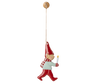 The Maileg Metal Ornament - Pixy, Candle Light features a hand-painted gnome in a red hat, scarf, and pants holding a white candle, hanging by a string—perfect for adding festive charm to your Christmas tree.