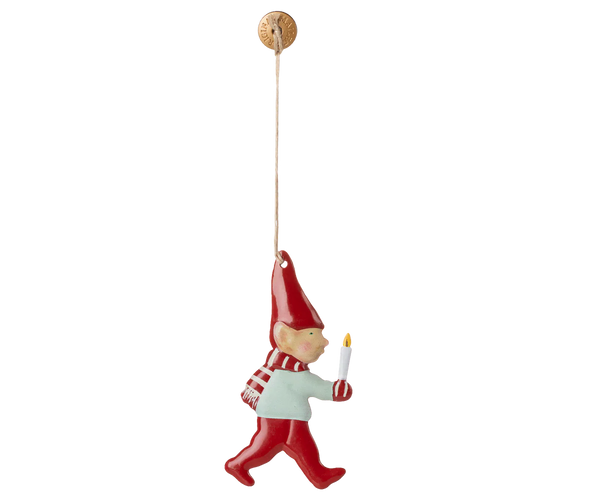The Maileg Metal Ornament - Pixy, Candle Light features a hand-painted gnome in a red hat, scarf, and pants holding a white candle, hanging by a string—perfect for adding festive charm to your Christmas tree.