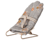The PRE-ORDER: Babysitter, My - Blue is a small fabric-covered rabbit chair bouncer with a beige metal frame and a blue cushion, available for shipment in late September.