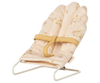 PRE-ORDER: Babysitter, Micro - Off White is a small, padded baby chair for micro rabbit furniture, featuring a white metal frame and yellow strap, shown angled against a plain background. Estimated ship date: late September.