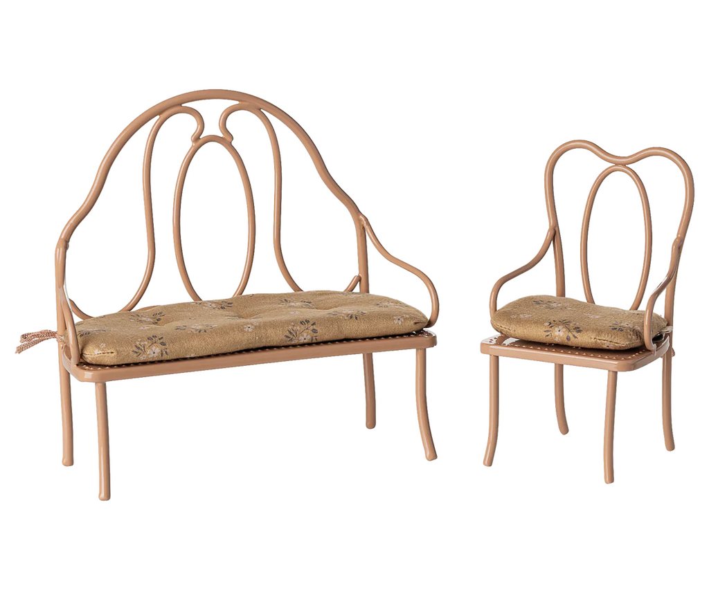 PRE-ORDER the Vintage Chair, Mini - Dark Powder (ships early October), a charming seat with a curved back and arms plus beige floral-patterned cushions—perfect for adding vintage style and comfort to any space.