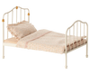 PRE-ORDER: Vintage Bed, Mouse Size - Off White. This small metal bed for mice features gold accents and comes with a ruffled pillow and pastel polka dot bedding on Maileg fabrics. Estimated ship date: Early October.