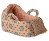 The PRE-ORDER Carry Cot in Baby Mouse Size - Rose (ships late November) is a small fabric cot with a pink quilted lining, two handles, and a woven tan toe cap—perfectly sized for baby mice.