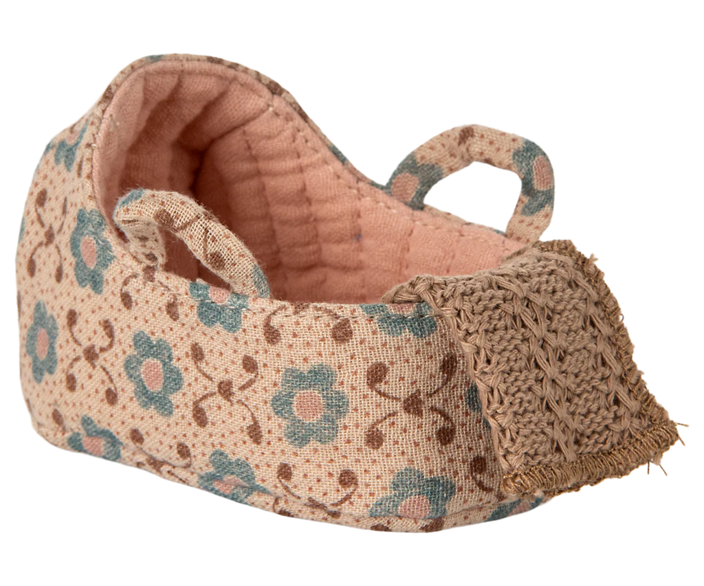 The PRE-ORDER Carry Cot in Baby Mouse Size - Rose (ships late November) is a small fabric cot with a pink quilted lining, two handles, and a woven tan toe cap—perfectly sized for baby mice.