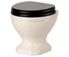 PRE-ORDER: Toilet, Mouse Size - Off White (ships early November). This mini white ceramic toilet features a black closed seat and lid, ideal for tiny mouse bathrooms or to complete your SuitCasa mouse house. Shown on a plain background.