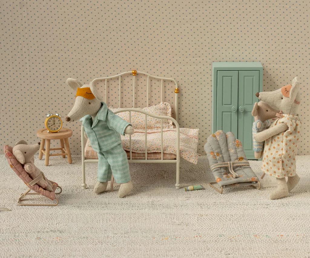 Dad Mouse wears Maileg Extra Clothing: Pyjamas for Dad Mouse, resting in a soft, polka-dotted miniature bedroom with his family. The cozy set includes a bed, chair, nightstand, alarm clock, and wardrobe.