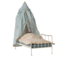 The Maileg Bed Canopy, Miniature - Mint (expected 04/15/26) is a small white metal canopy bed with blue-striped bedding, a floral blanket, sheer cotton mint canopy, and a plush rabbit—ideal for romantic bedroom decor.