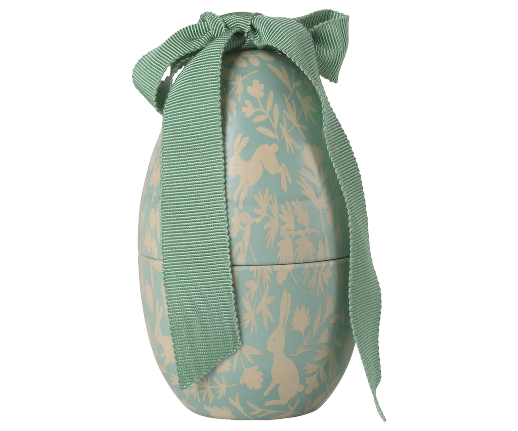 The Maileg Easter Egg, Small - Dusty Mint features a decorative egg-shaped metal box with a green and beige rabbit and foliage design plus a textured ribbon bow—an adorable collectible, expected by 02/15/26.