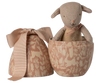 The Maileg Easter Egg with Micro Lamb, Small - Powder features a soft brown plush lamb in a decorative tan egg-shaped container with a nature design and ribbon-topped lid, making a charming gift.