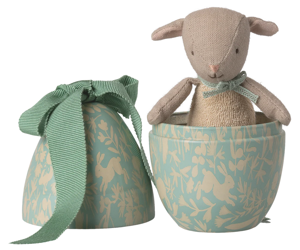 The Maileg Easter Egg with Micro Lamb, Small - Dusty Mint features a soft lamb inside a blue and cream egg-shaped box with playful animal and plant patterns—a delightful gift for children. Expected arrival by 02/15/26.