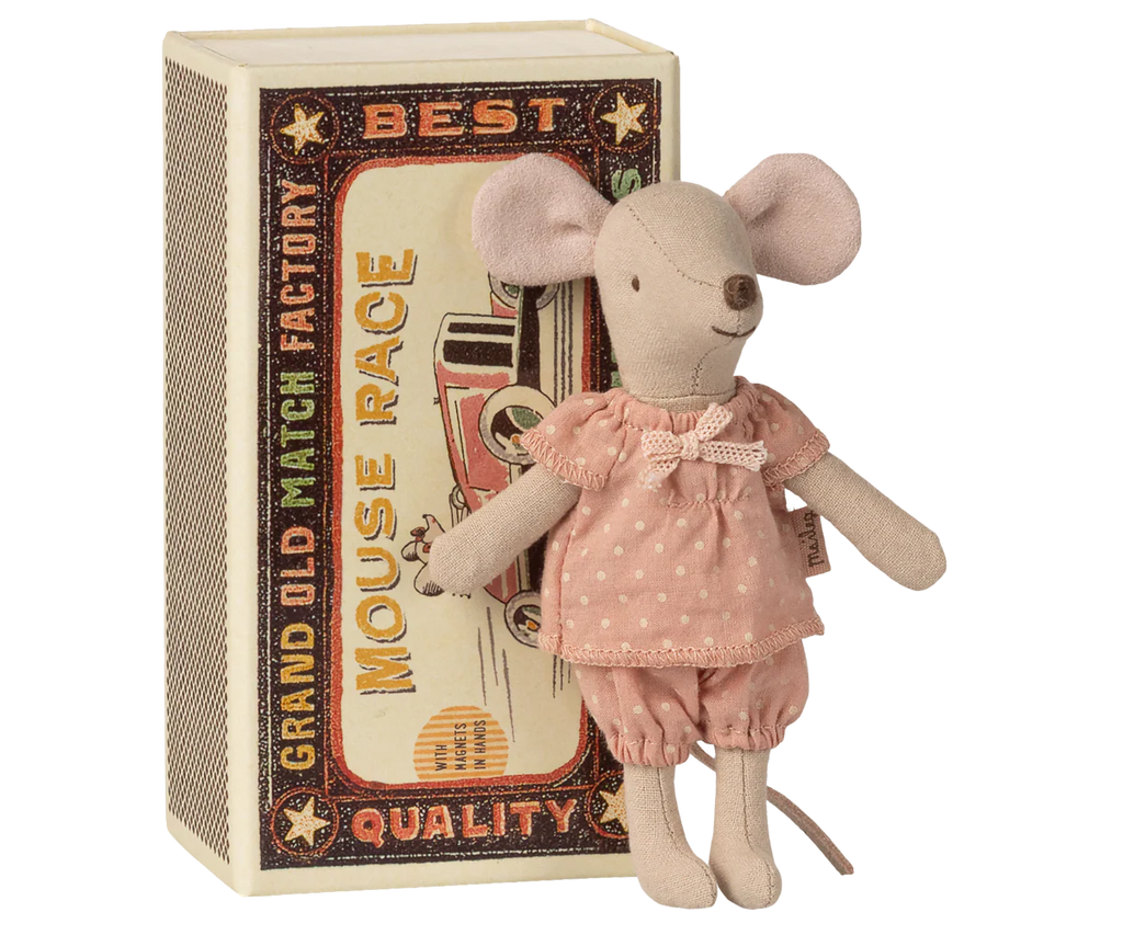 The Maileg Big Sister Mouse in Matchbox, dressed in a pink polka-dot dress, stands by a vintage-style matchbox labeled "Best Mouse Race.