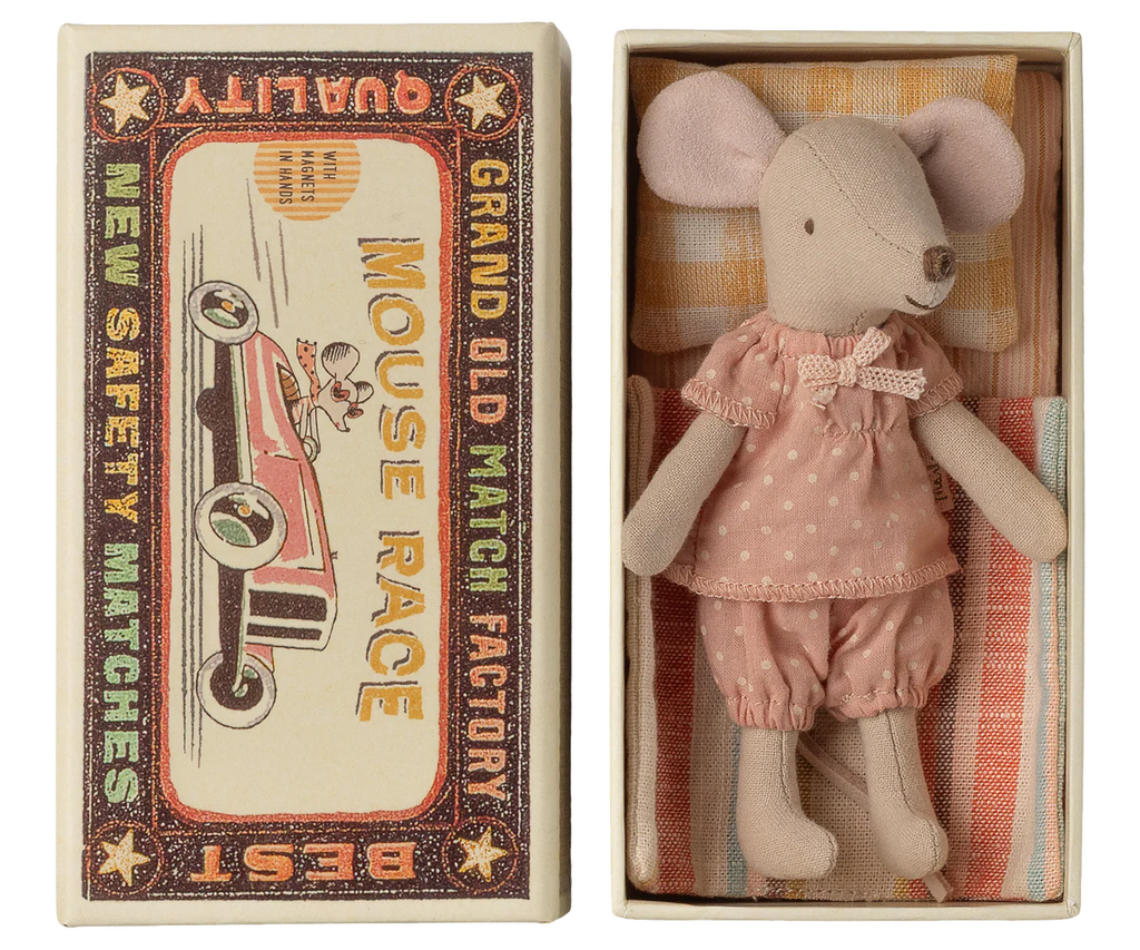 The Maileg Big Sister Mouse in pink pajamas rests in a matchbox toy bed with soft fabric bedding, featuring vintage-style “MOUSE RACE” and “GRAND OLD MATCH FACTORY” art. Expected arrival: 03/01/26.