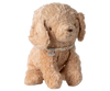 The Maileg Puppy, Small - Dusty Powder, a light brown cotton plush dog with floppy ears and a patterned collar, sits upright against a plain white background.