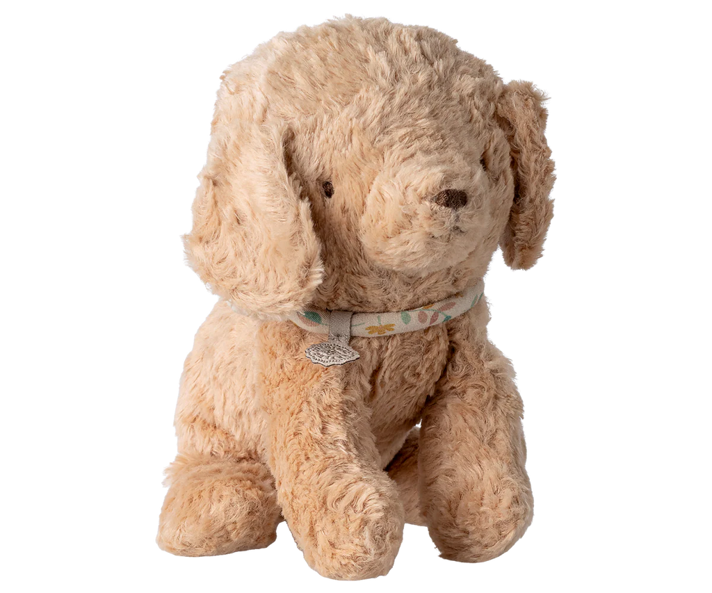 The Maileg Puppy, Small - Dusty Powder, a light brown cotton plush dog with floppy ears and a patterned collar, sits upright against a plain white background.