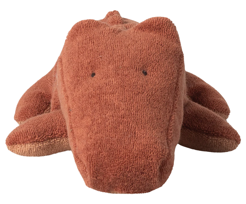 The Maileg Crocodile, Small - Vintage Rose (arriving 06/15/26) is a huggable plush shaped like a crocodile, crafted from soft brown fabric with stitched black eyes, lying flat with spread legs.