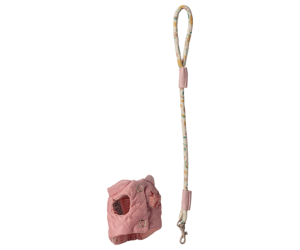 The Maileg Pet Supply Harness and Leash - Rose, a pink quilted puppy harness with metal snaps, is displayed next to a patterned set with loop handle and metal clip. Both stylish accessories are shown on a white background. Expected arrival: 03/01/26.