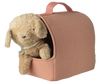 A soft puppy plush with a collar peeks out of the Maileg Pet Carrier - Coral, which has a handle on top and an open front. One paw and the pup’s head are visible against a plain white background.