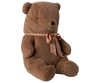 The Maileg Teddy Bear Plush, Medium – Soft Brown sits upright with a peach-colored ribbon around its neck and features a huggably soft texture, shown against a plain white background.