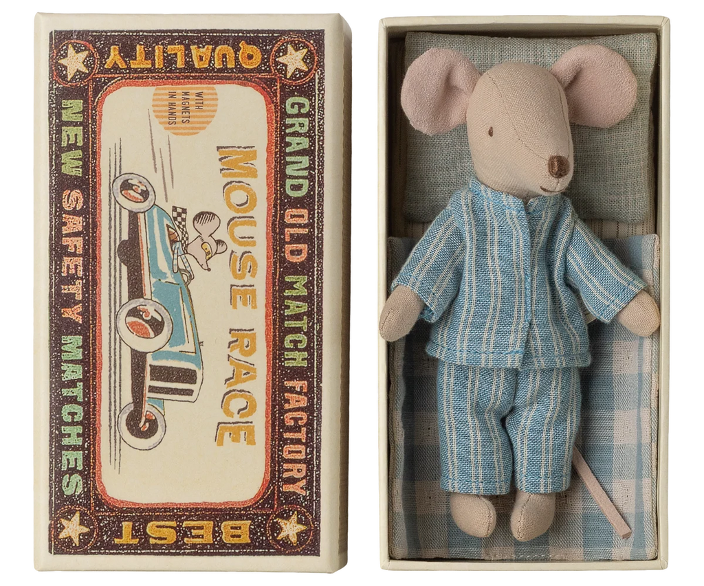 A small soft fabric mouse, Maileg Big Brother, dressed in blue striped pajamas, lies inside a box designed to resemble a classic matchbox toy. The box lid features vintage racing graphics and the text “Mouse Race” and “Grand Old Match Factory,” making it the perfect gift for any Maileg mouse collector.