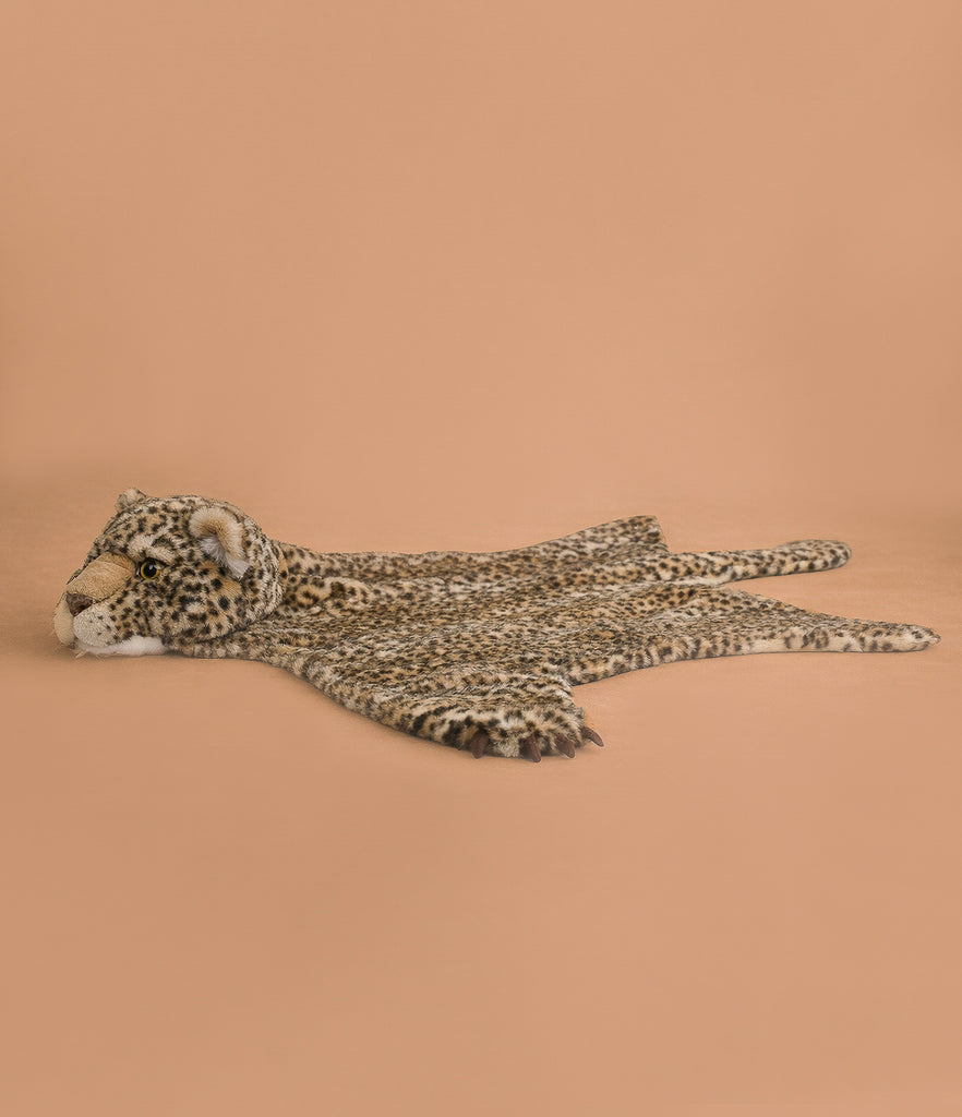 The Costume - Leopard features soft faux fur in a plush leopard shape, lying flat with raised head and spread legs on a beige background—an ideal gift for kids.