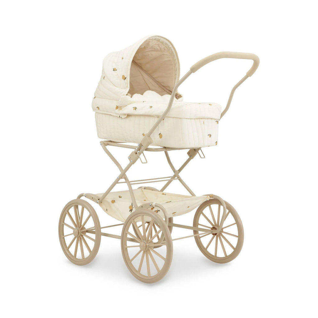 The Konges Sloejd Doll Pram - Lemon features a cream quilted fabric with subtle patterns, a curved handle, large spoked wheels on a beige frame, and includes an organic cotton mattress for extra comfort.