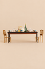 A Maileg Dining Set Set for four, featuring a tureen, bowls, glassware, and two bottles, flanked by two ornate Mouse Size Gold Chairs.