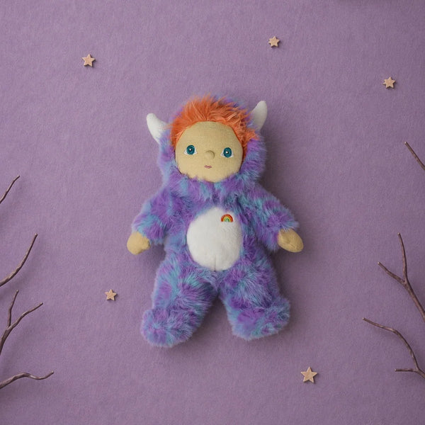 Olli Ella Dinky Dinkum Doll - Miles Monster plush with glow-in-the-dark blue and purple fur, an orange-haired hood, and a small rainbow embroidered on its white belly.