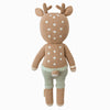 Cuddle + Kind Elliott the Fawn is a hand-knit, fair trade plush deer with light brown fur, white spots, antlers, and mint green pants. This hypoallergenic stuffed toy is shown from the back against a white background.