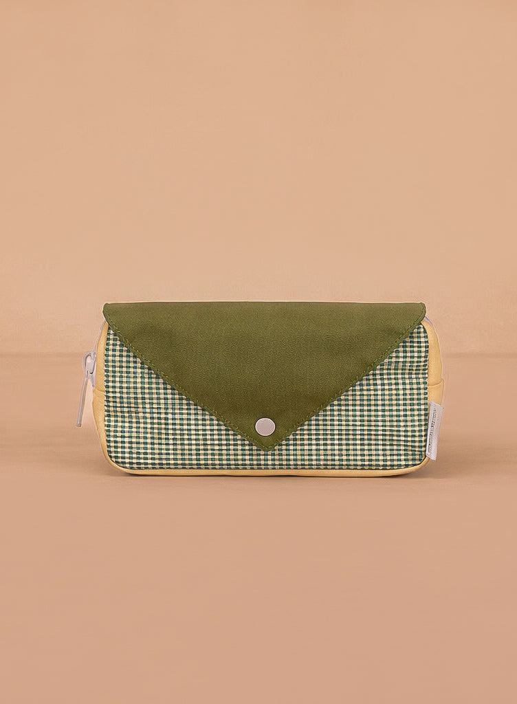 The Sticky Lemon Fanny Pack Small - Envelope - Tickling Grass is a rectangular pouch made from recycled PET bottles with a green snap flap, green and white checkered front, yellow sides, and shown on a plain beige background.