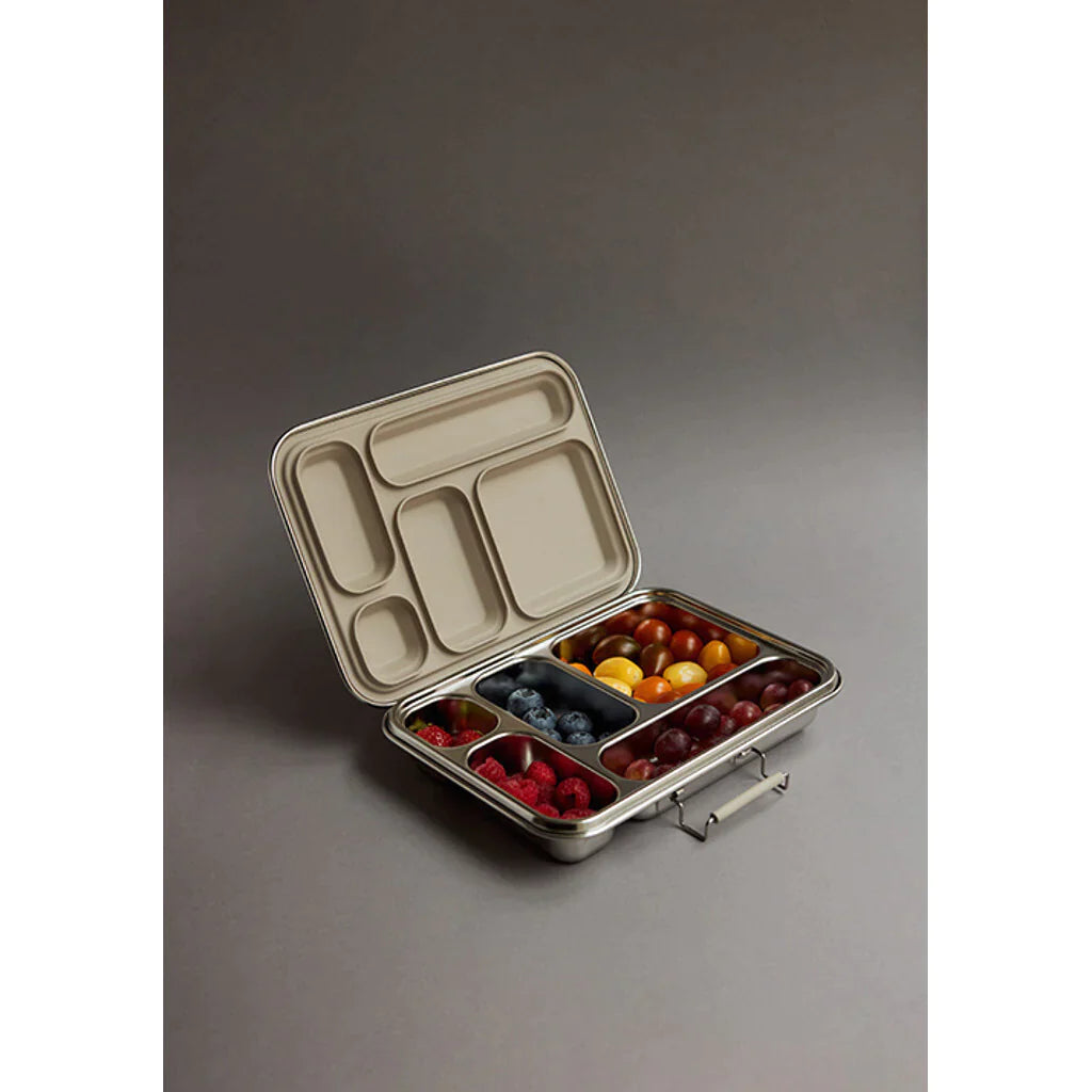 The Haps Nordic - Stainless Steel Lunch Box - Multi-Compartment (ships in approximately two weeks) is a sleek stainless steel lunchbox with multiple compartments containing assorted fruits, including blueberries, cherry tomatoes, raspberries, and grapes. Perfect for meal prep, the lid is open to reveal the neatly arranged contents inside against a neutral background.