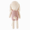 Cuddle + Kind Harper the Bunny is a hand-knit doll with long ears, a pink romper, and a white pom-pom tail, shown from the back on a white background.