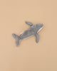 The Senger Naturwelt Cuddly Animal - Whale, a gray plush toy with a white underside made from organic cotton, is displayed on a plain beige background.