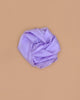 Sarah's Silks Solid Color Playsilk in Lavender, inspired by Playsilks, is displayed in a circular arrangement on a plain beige background.