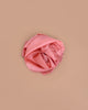 Sarah's Silks Solid Color Playsilk in Peach, perfect for sensory play, is softly crumpled and arranged in a loose circle on a light brown background.