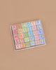 ABC Learning Blocks is a wooden alphabet puzzle with colorful square letter pieces in pastel shades, arranged in rows on a light brown board. It's the perfect educational toy for toddlers to develop early literacy skills from A to Z.
