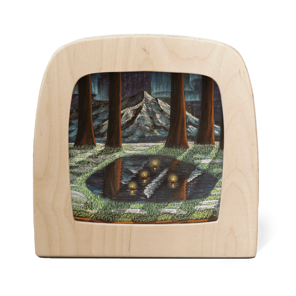 The "Silhouette Only - February for Toverlux Lamp" showcases a wooden frame with translucent nighttime forest art—mountain, tall trees, pond with glowing orbs, stars, and green northern lights—ideal as a unique home accessory. Ships in one week.