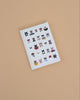 The Studious Cats Embroidered Journal features a white cover adorned with embroidered cats in playful poses and accessories, making it an ideal gift for any cat lover.