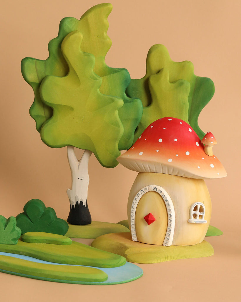 The Bumbu Wooden Toadstool House features a charming, round mushroom home with a red, white-spotted roof, surrounded by green trees, shrubs, and a blue stream on a beige background—ideal for imaginative play.