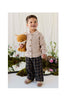 A young child wearing a beige cardigan and plaid trousers smiles while holding a Snuggle Bunnies - Archie the Fox - Natural plush.